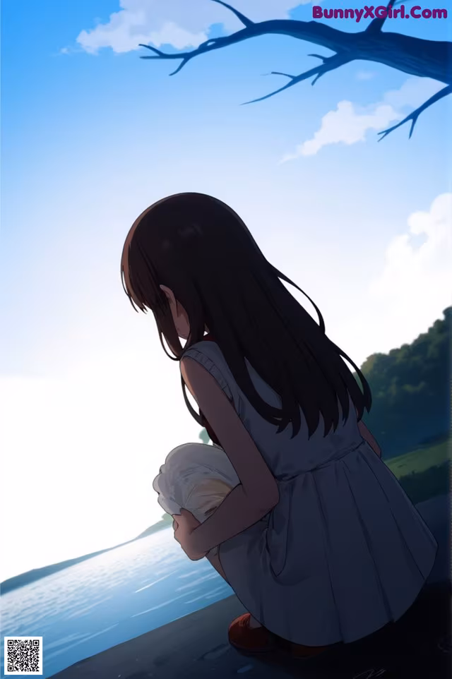 A girl in a white dress sitting on the edge of a lake.