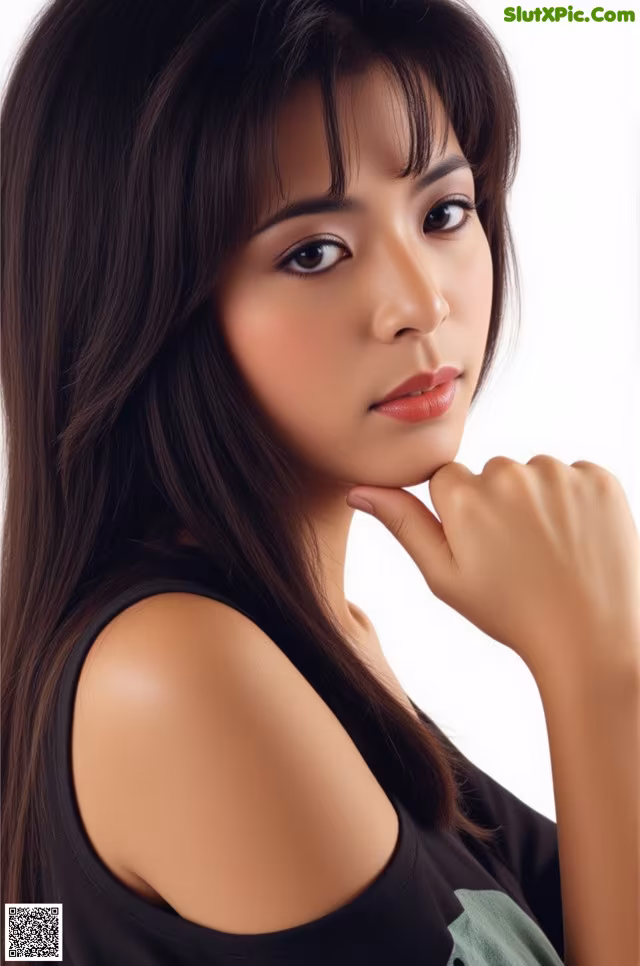 A woman with long black hair is posing for a picture.