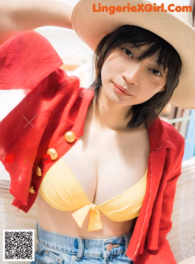 A woman in a yellow bikini top and a straw hat.
